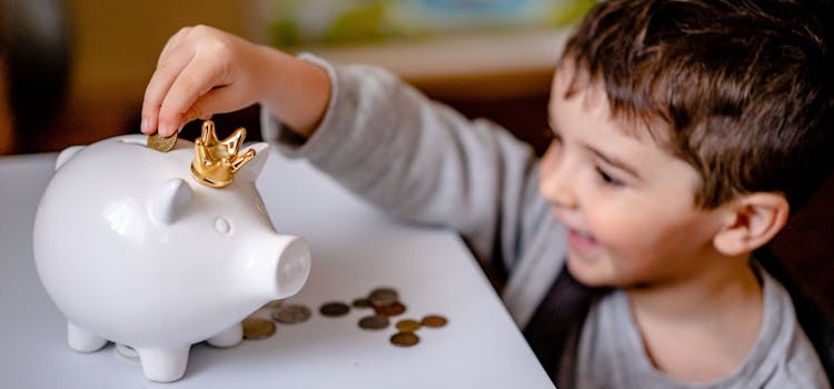 dete ubacuje novac u kasicu 